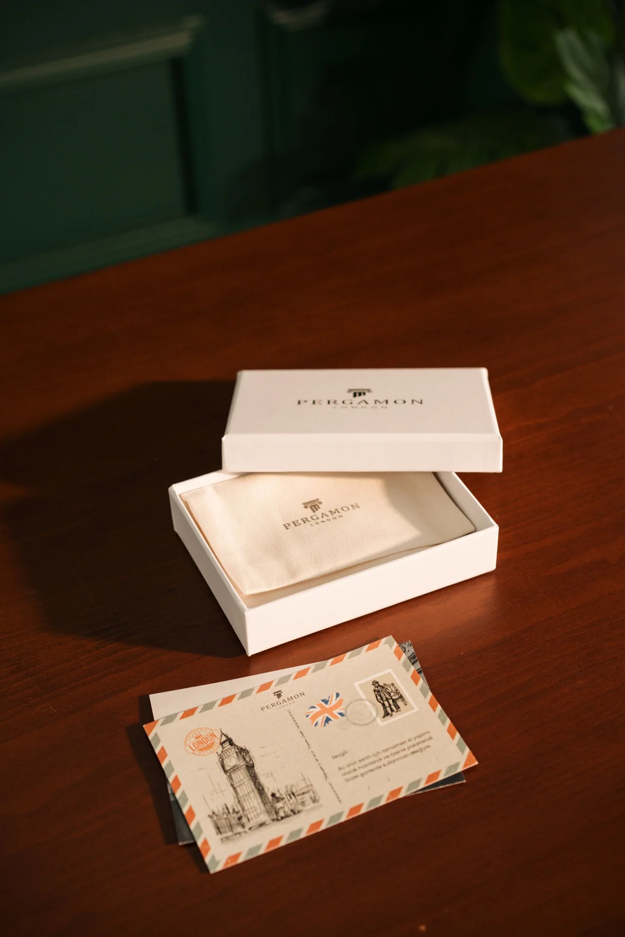 A wrapped gift with a card on a wooden table